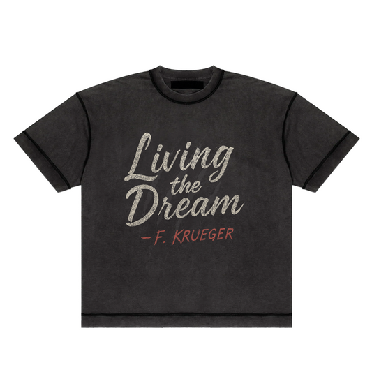 Screaming Saints black 'Living the Dream' unisex t-shirt with a vintage-style graphic and 'F. Krueger' text.