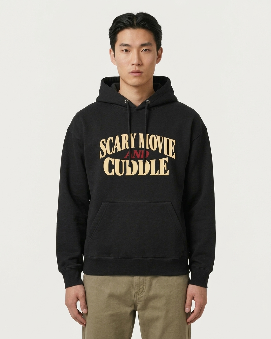 Man wearing the black Scary Movie and Cuddle horror hoodie, front view, true to size unisex fit.