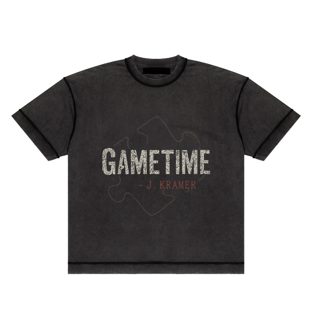 Screaming Saints black 'Gametime' unisex t-shirt with a vintage-style puzzle piece graphic and 'J. Kramer' text.